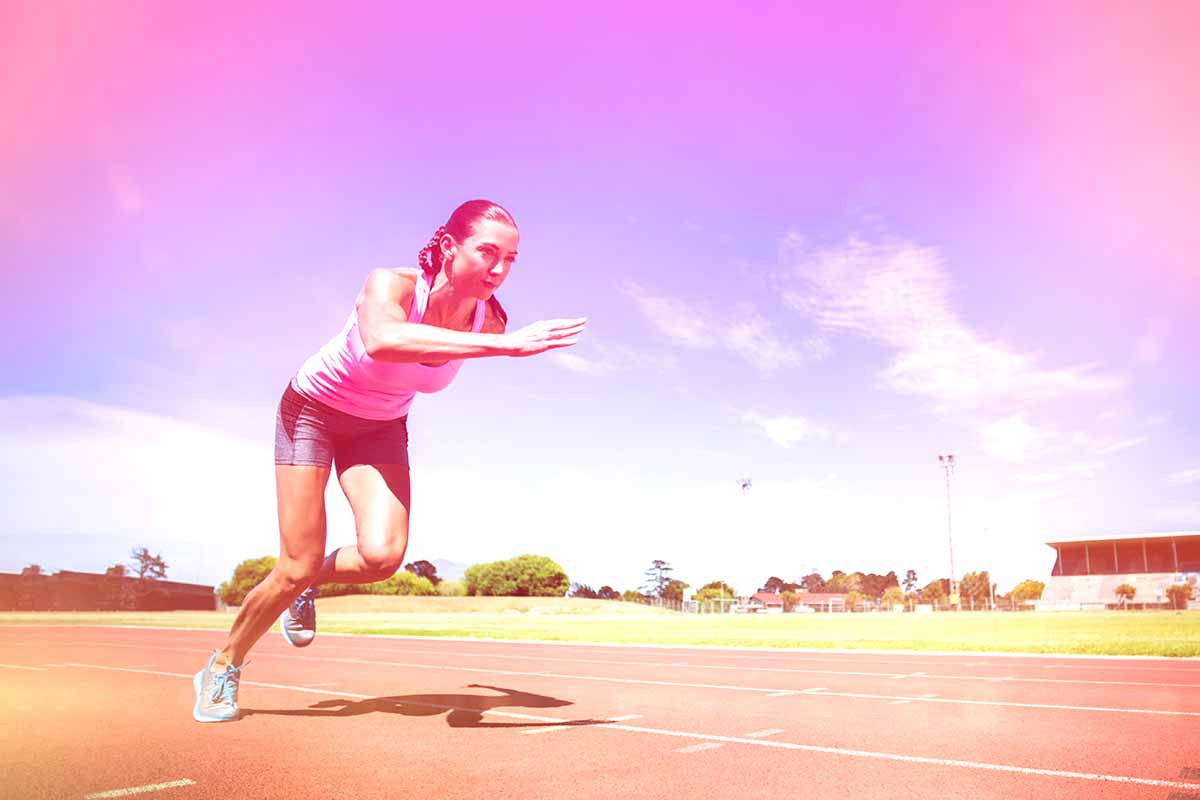 Types of running workouts - female sprinting on a track